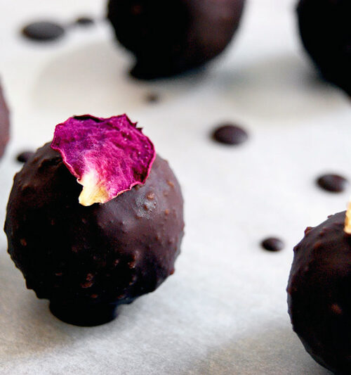 Marzipan truffles with rose petals on top.