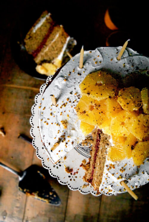 Top down view of orange-topped layer cake.