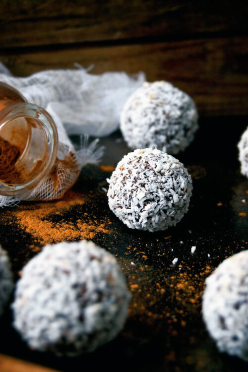 Several coconut snowball cookies with cinnamon.