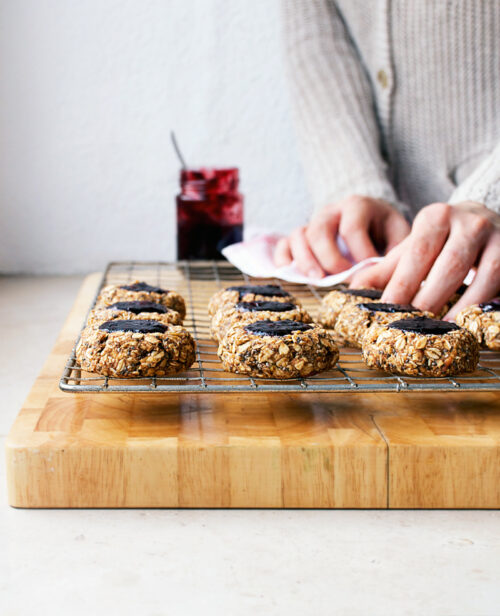 Jam thumbprint cookies on a wire rack.