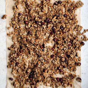 Hazelnut granola on a rectangle of parchment paper.