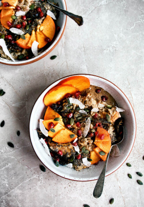 Two bowls of porridge with persimmon, seeds, and nut butter.