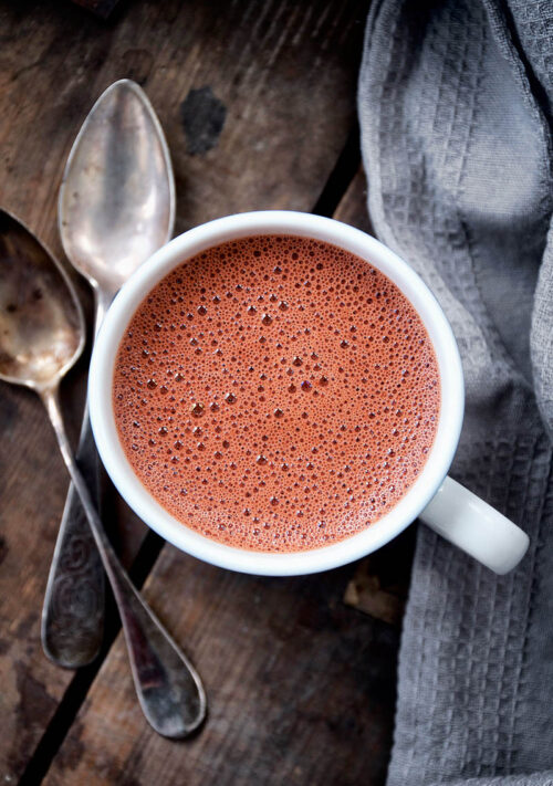Top down view of hot chocolate in a small mug.