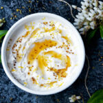 Top down view of thickened yogurt in a dish.