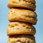 A stack of four biscuits with a blue background.