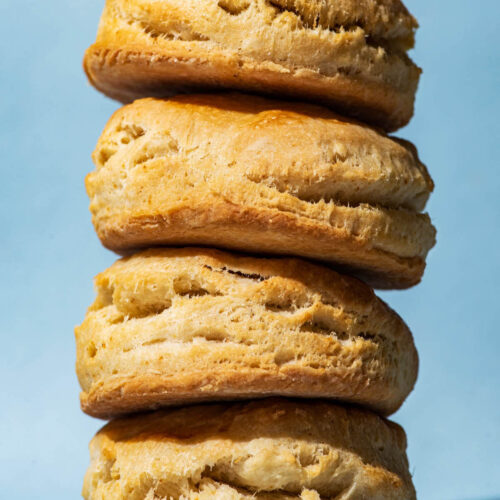 A stack of four biscuits with a blue background.