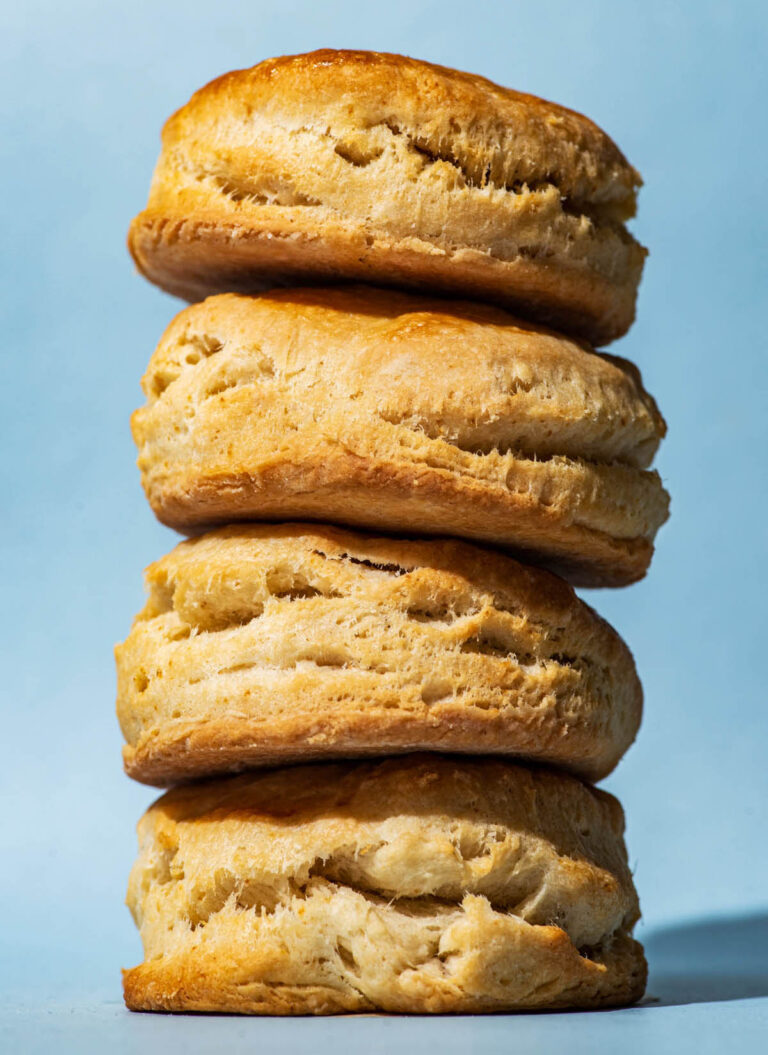 A stack of four biscuits with a blue background.