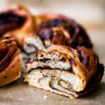 A slice of chocolate orange babka removed slightly from the loaf.