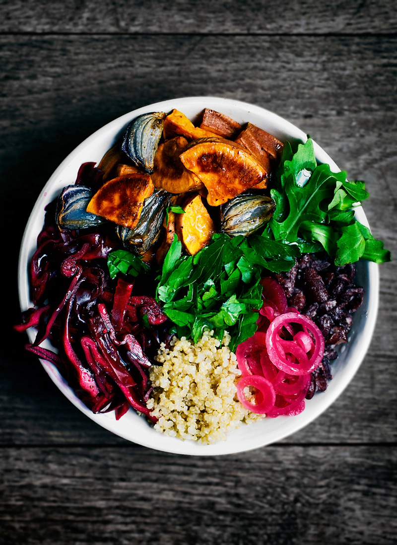 Winter energy bowl with quinoa, red cabbage, roasted sweet potato, and pickled onions.