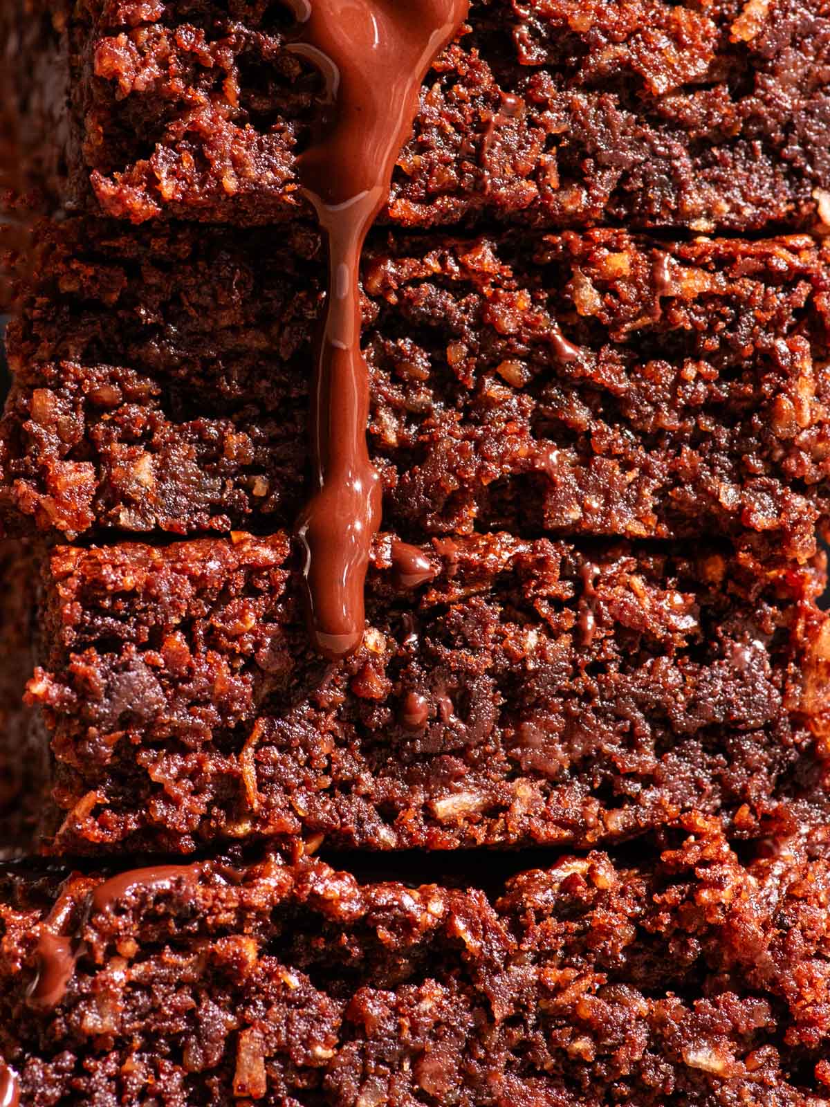 Close up of a stack of brownies with melted chocolate.