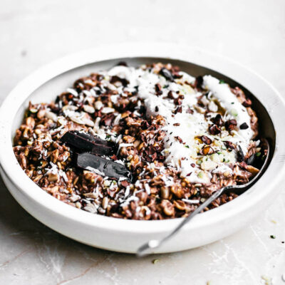 Chocolate overnight oats in a shallow bowl with extra yogurt.
