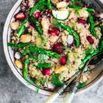 Strawberry, radish, cucumber, and asparagus quinoa salad in large bowl.