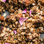 Close up of granola with dried pink rose petals.