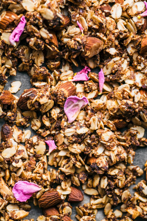 Close up of granola with dried pink rose petals.