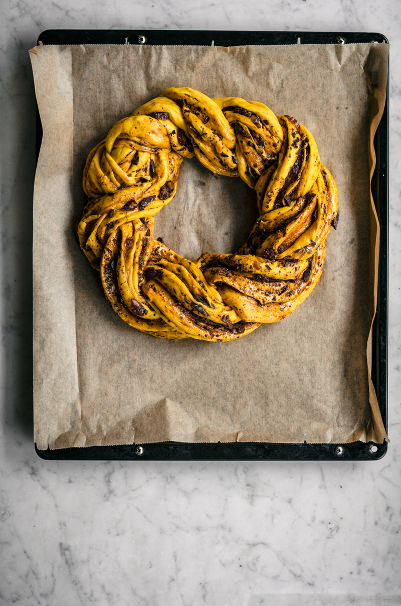 Unbaked braided saffron bread, in a wreath shape, unbaked.