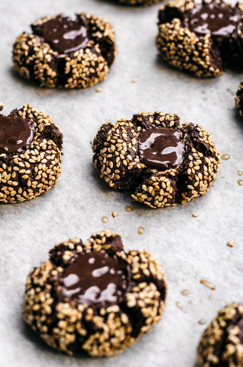 Chocolate thumbprint cookies with sesame seeds and melted chocolate centre.