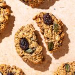 Breakfast cookies on a stone background, one broken in half.