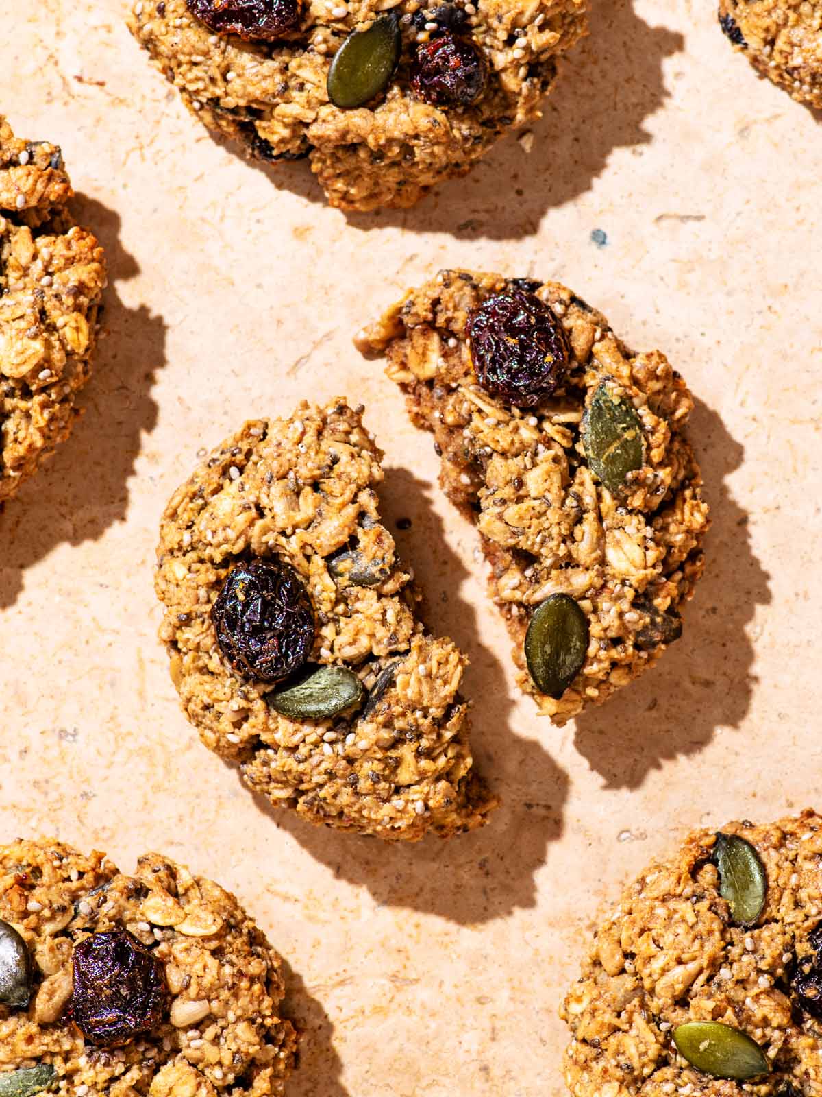 Breakfast cookies on a stone background, one broken in half.