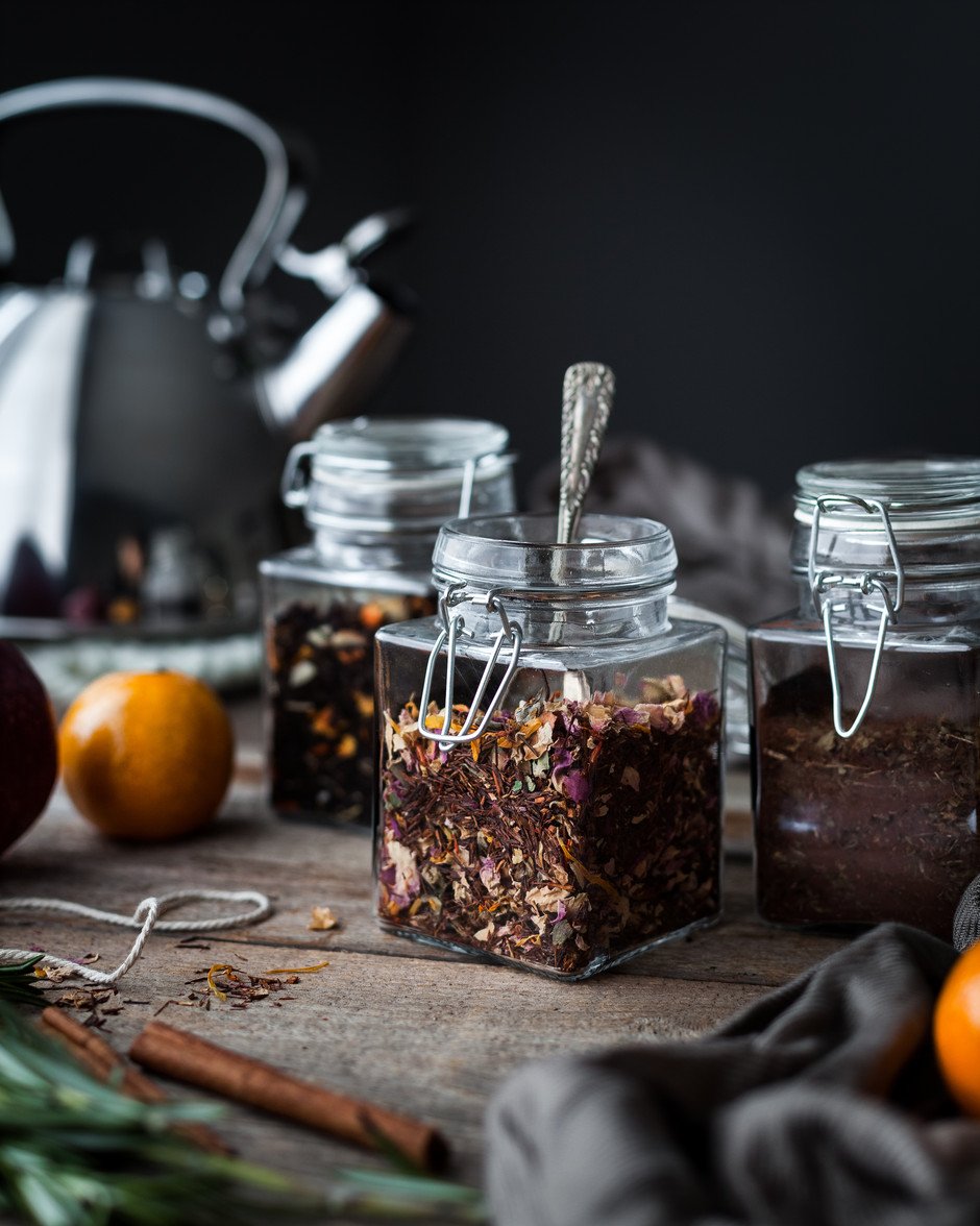 Three small glass jars filled with fruit tea blends.