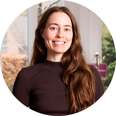 The author, a woman with long brown hair, smiling at the camera.