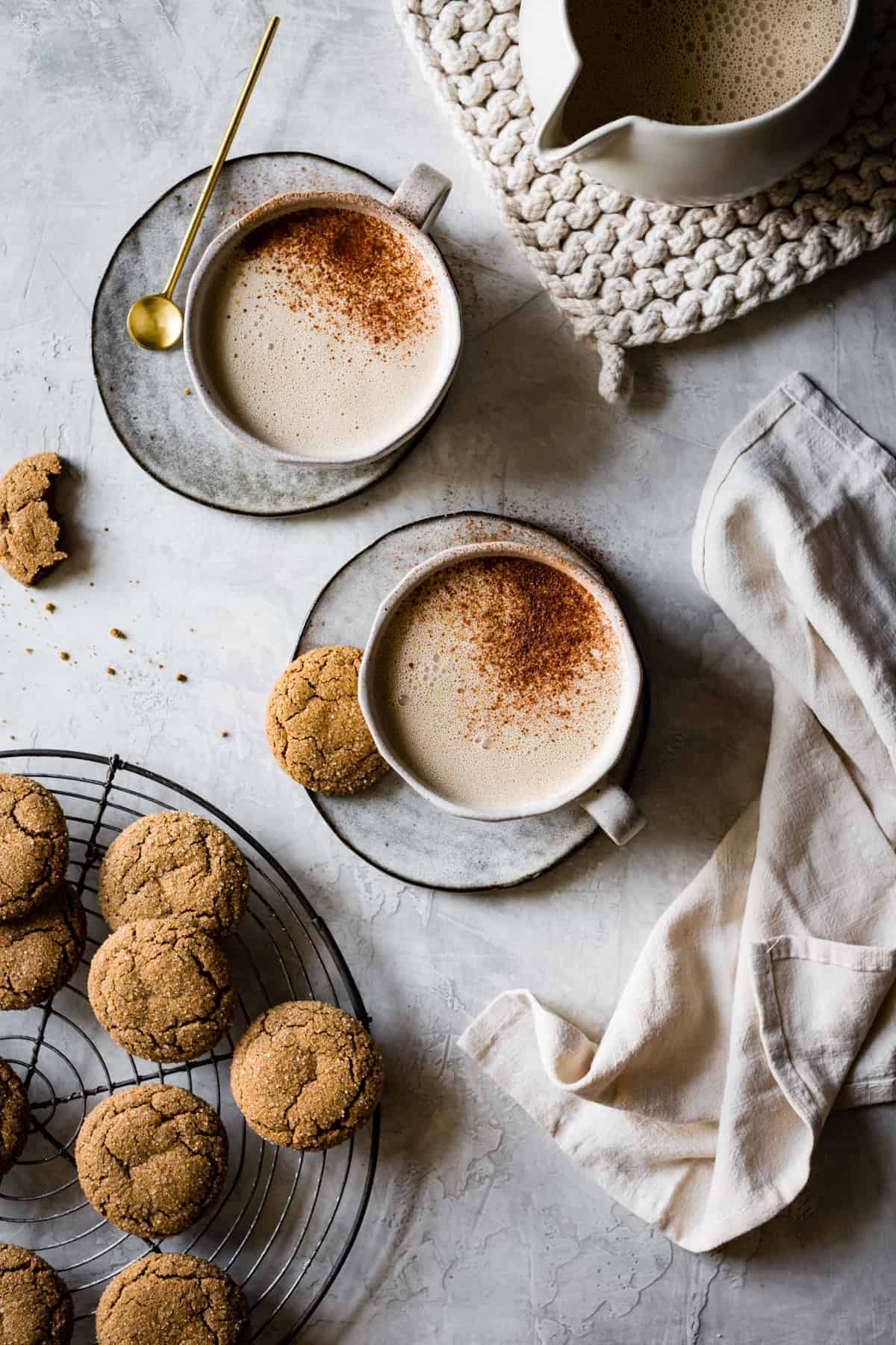Two mugs with lattes and topped with cinnamon.