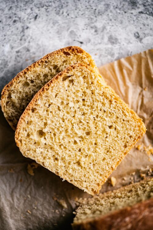 Slices of bread, top down view, on parchment paper.