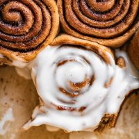 Cinnamon rolls, close up, one with icing.