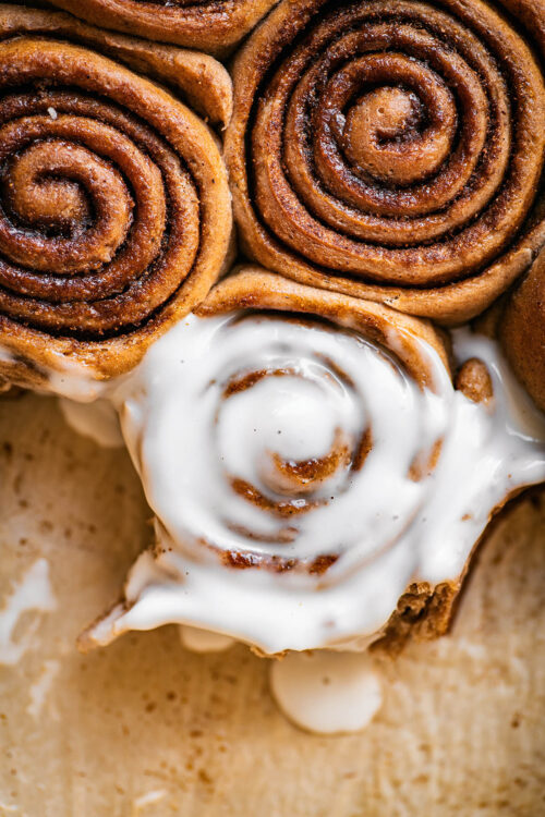 Cinnamon rolls, close up, one with icing.
