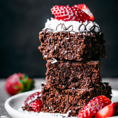 A stack of breakfast brownies with yogurt and strawberries.