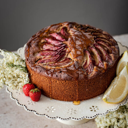 Rhubarb lemon cake on a cake stand.