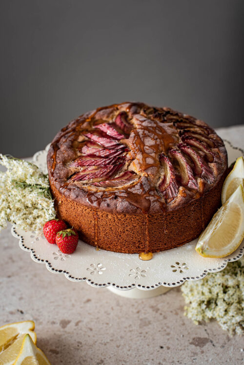 Rhubarb lemon cake on a cake stand.