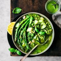 Spring minestrone with asparagus in a bowl with a spoon.