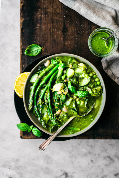Spring minestrone with asparagus in a bowl with a spoon.