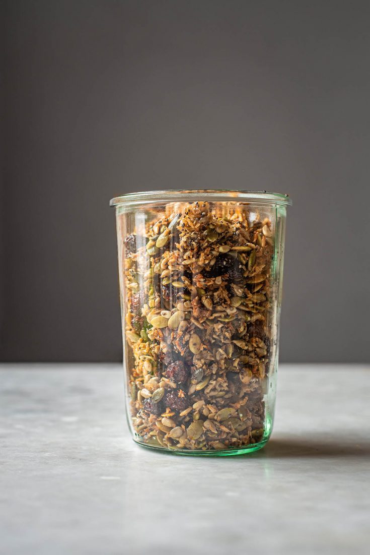 Grain free granola with dried cranberries in a jar, front view.