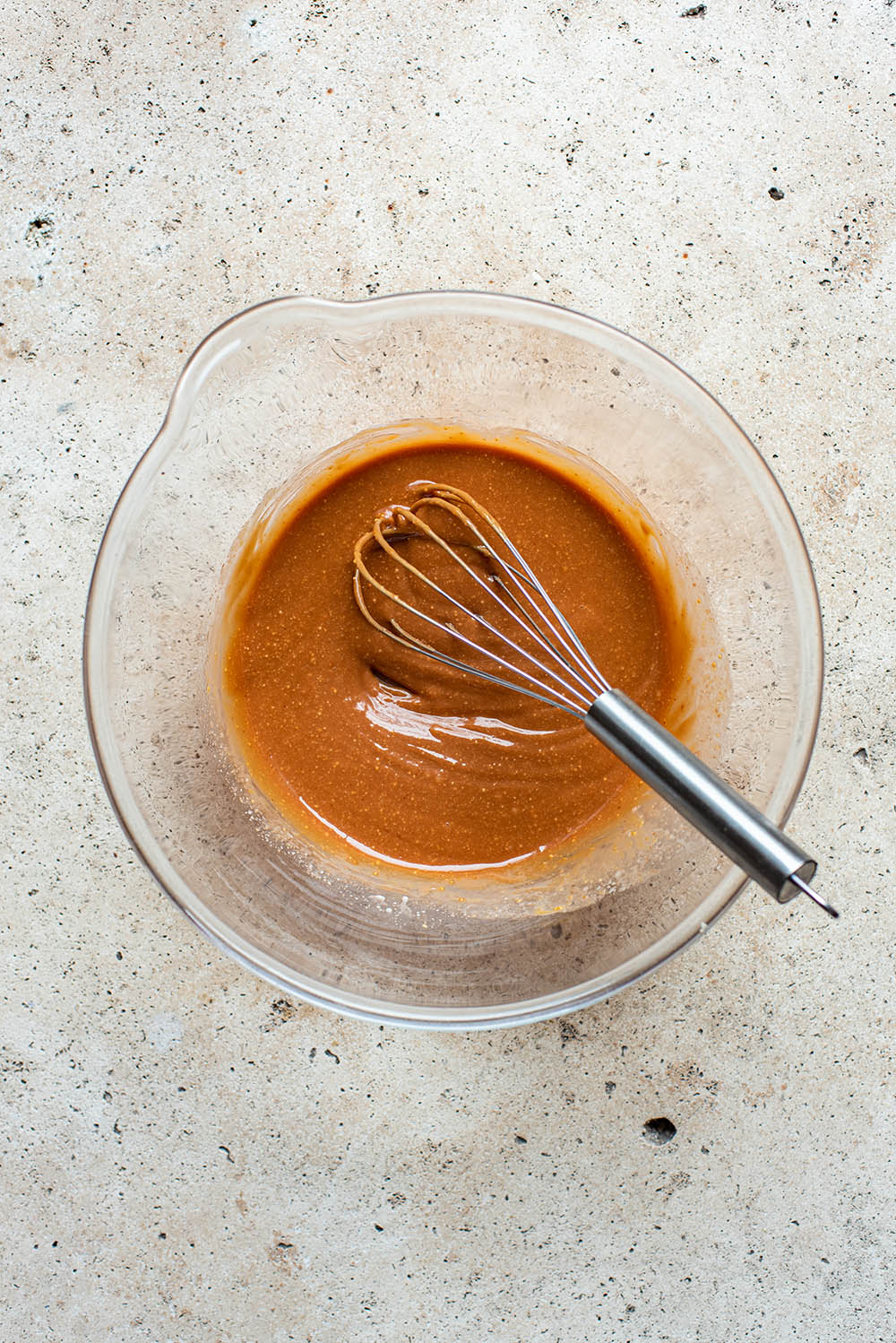 Whisked peanut butter mixture in a large glass bowl.