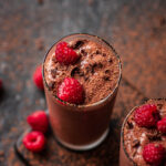 Chocolate raspberry protein shakes topped with chocolate and berries.