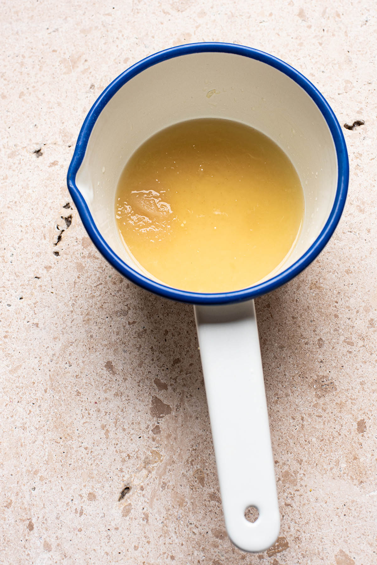 A small saucepan with lemon juice, honey, and agar powder.