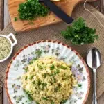 Cauliflower risotto in a bowl with herbs.