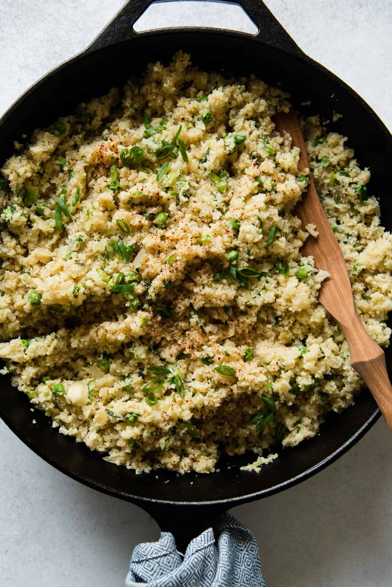 Close up of cauliflower rice in a frying pan.