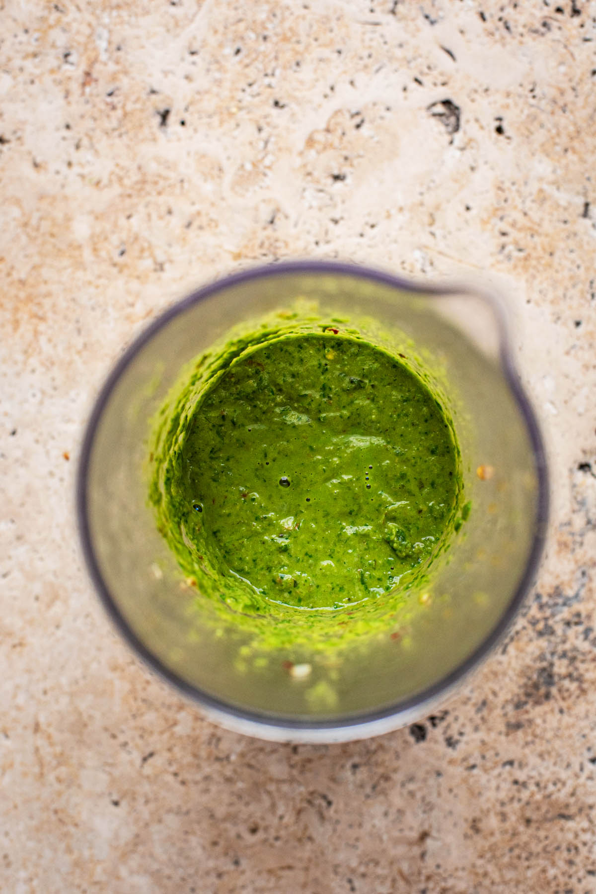 Green pasta sauce in a blending container.