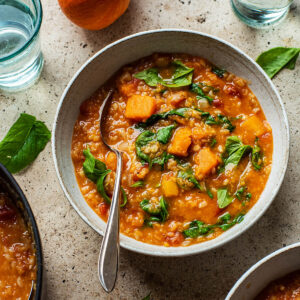 Rice and lentil soup in a bowl with a spoon.
