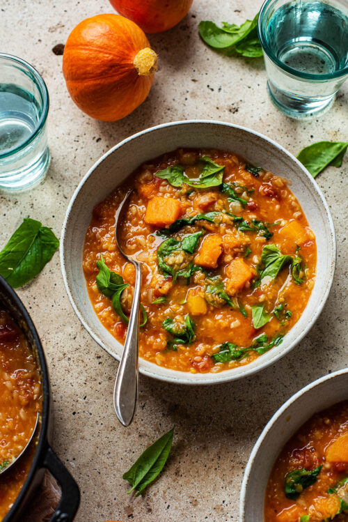 Rice and lentil soup in a bowl with a spoon.