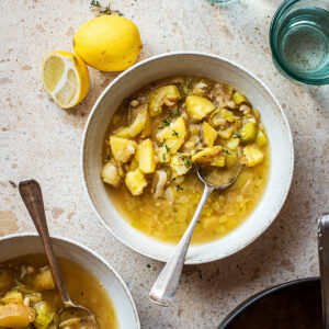 Two bowls of soup with the pot.