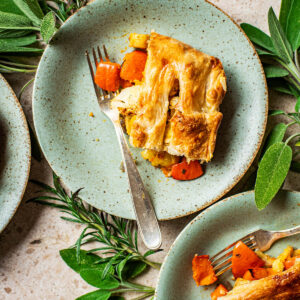 Plates with pieces of puff pastry pie on them.