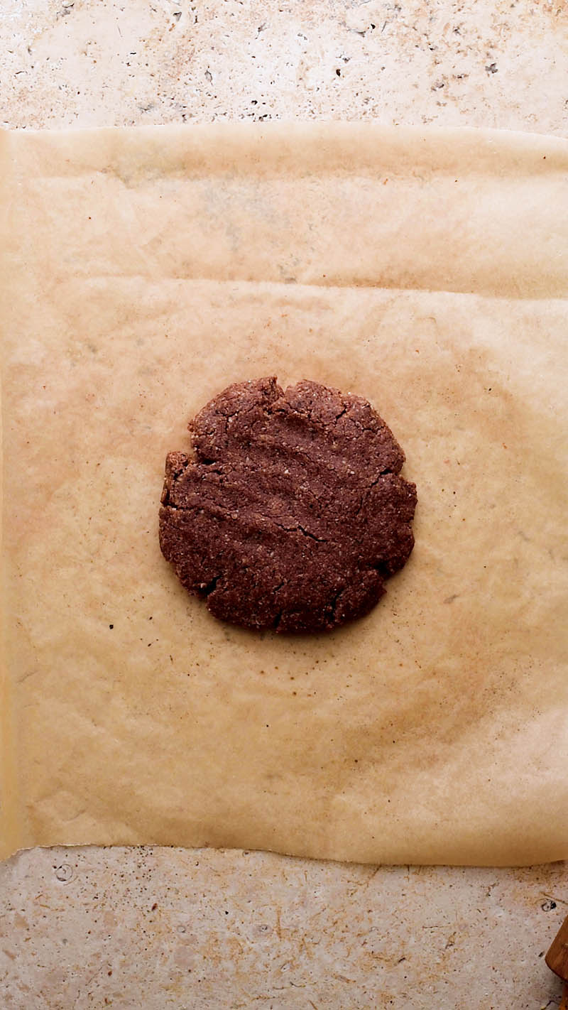 Disc of mixed dough placed onto parchment paper.