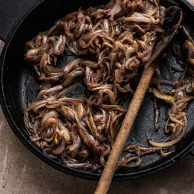 Red wine caramelised onions in a cast iron pan.