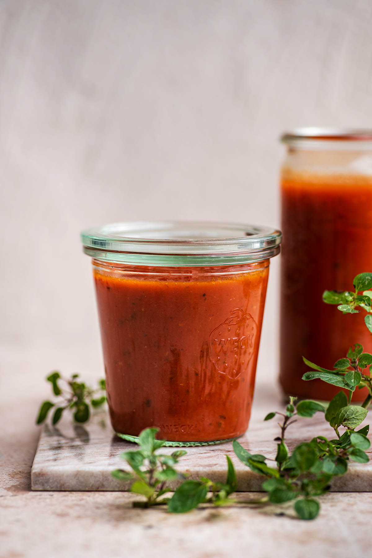Tomato sauce in a glass jar with a lid.