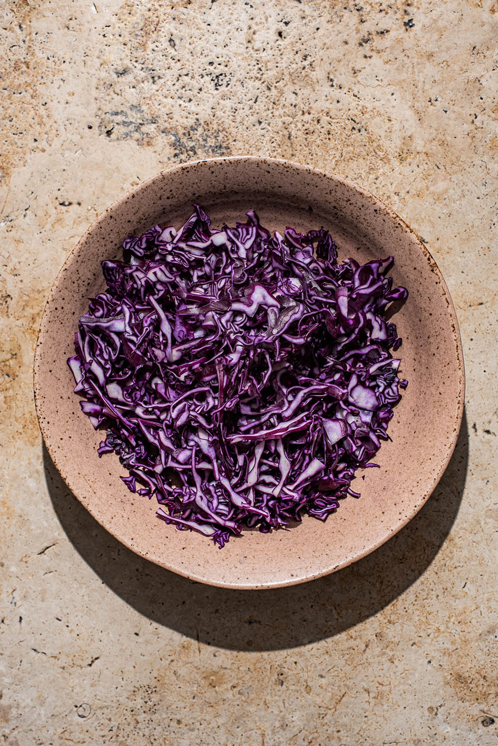 Shredded red cabbage in a bowl.