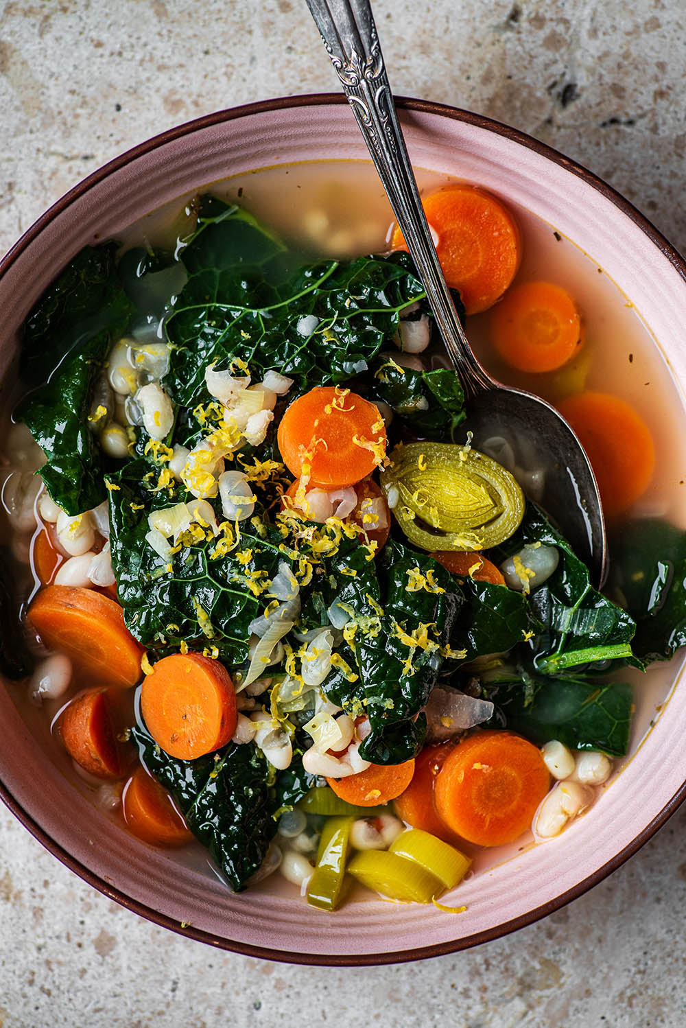 Close up of kale soup in a bowl.
