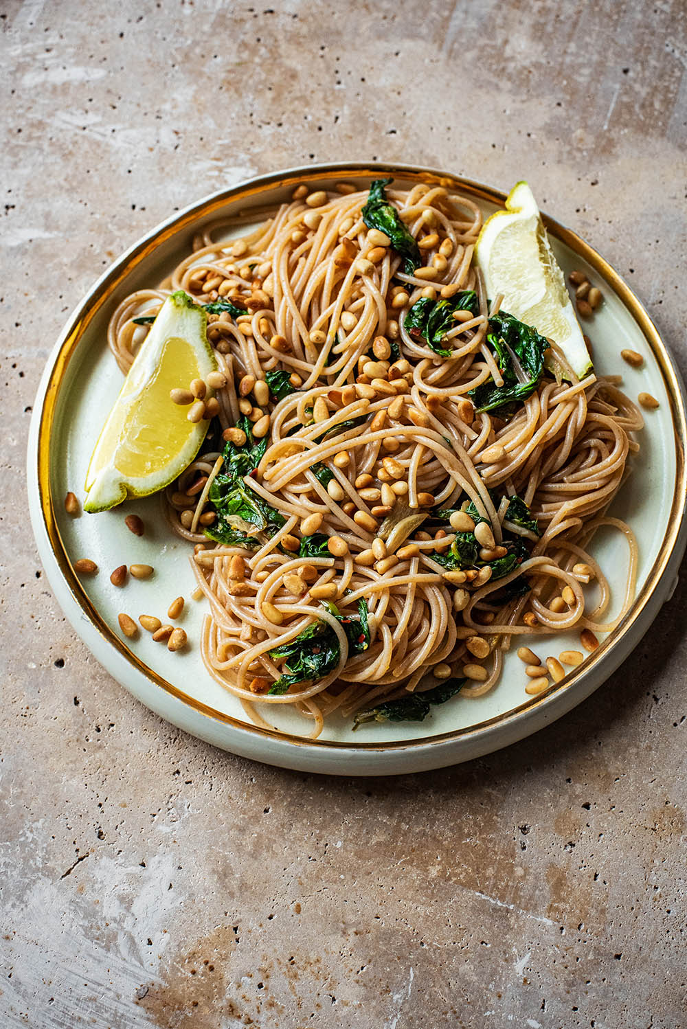 Close up of spaghetti with spinach and cedar nuts.